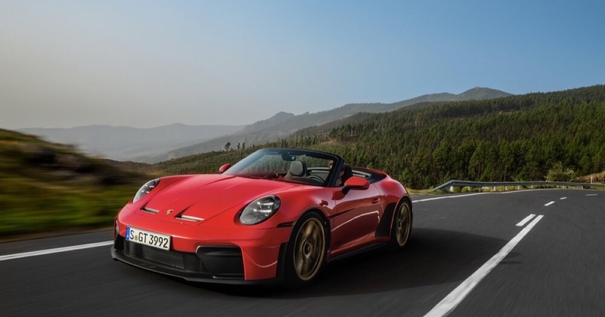 Porsche 911 GT3 S/C in Guards Red with the top down, driving on a mountain road